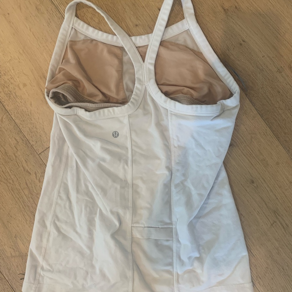 A size 6 cream colored lululemon tank top with a built in bra.